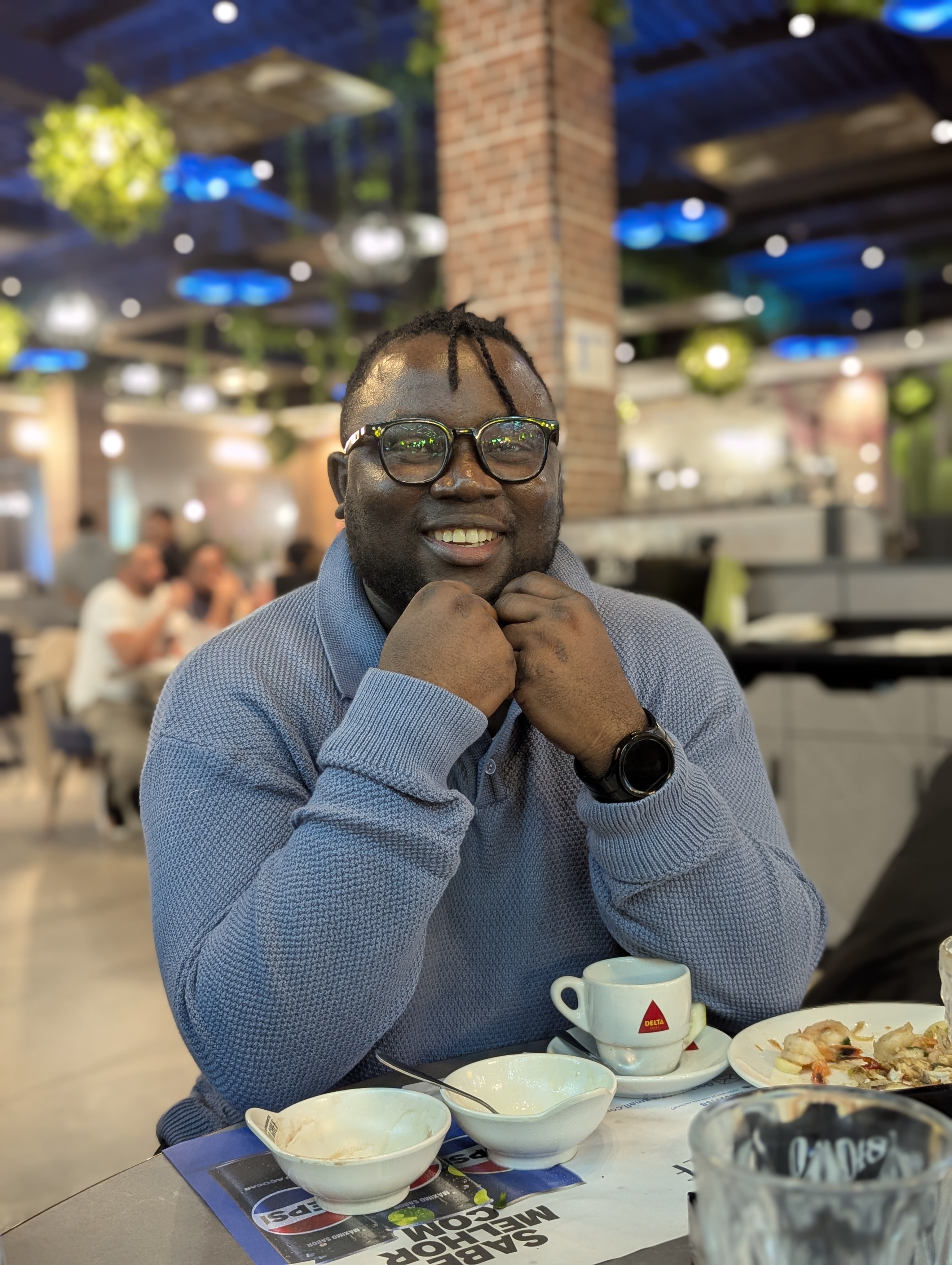 Justice Otuya, Senior Frontend & Mobile Developer, smiling in a casual setting